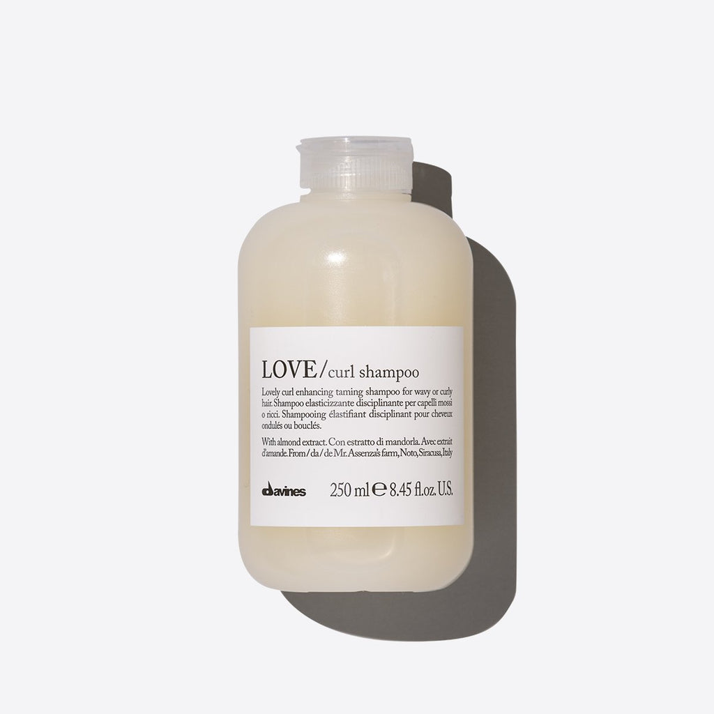 Bottle of Love Curl Shampoo with a white label on a white background