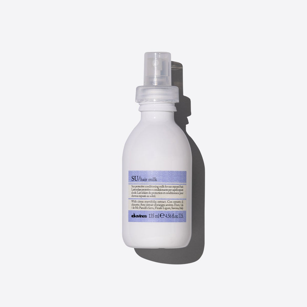 Bottle of SU Hair Milk on a white background